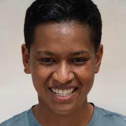 Joyful black young-adult female with short  brown hair and brown eyes