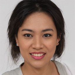 Joyful asian young-adult female with medium  brown hair and brown eyes