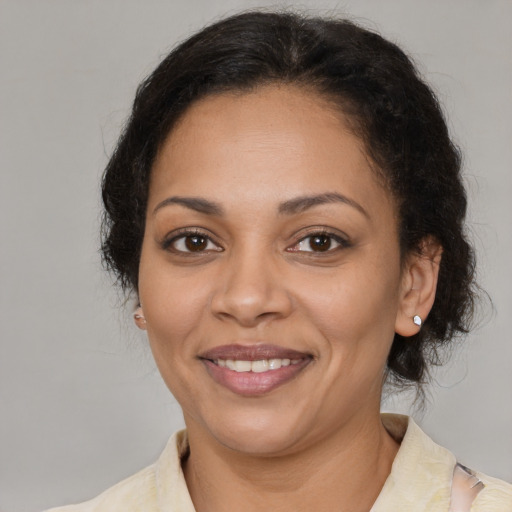 Joyful latino adult female with medium  brown hair and brown eyes