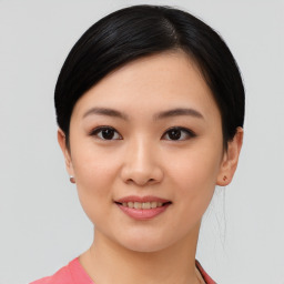 Joyful asian young-adult female with short  black hair and brown eyes