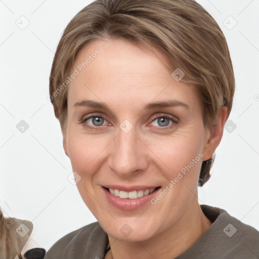 Joyful white adult female with short  brown hair and grey eyes