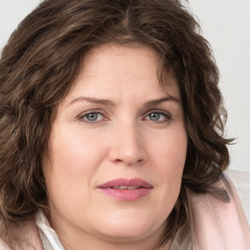 Joyful white young-adult female with medium  brown hair and green eyes