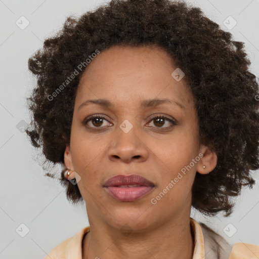 Joyful black adult female with medium  brown hair and brown eyes