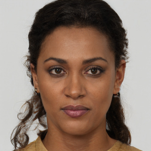 Neutral black young-adult female with medium  brown hair and brown eyes