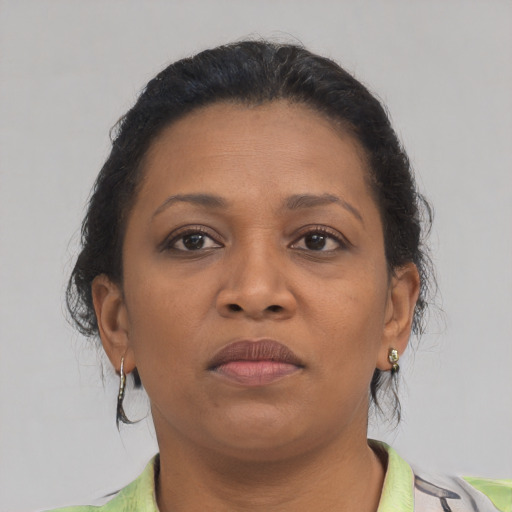 Neutral black young-adult female with medium  brown hair and brown eyes