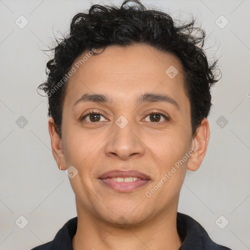 Joyful latino adult male with short  black hair and brown eyes