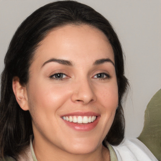 Joyful white young-adult female with medium  brown hair and brown eyes