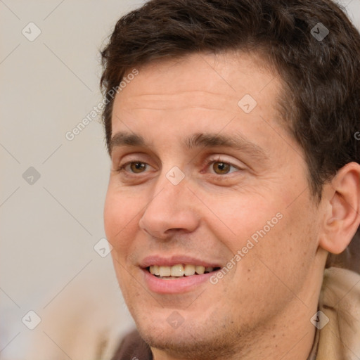 Joyful white adult male with short  brown hair and brown eyes