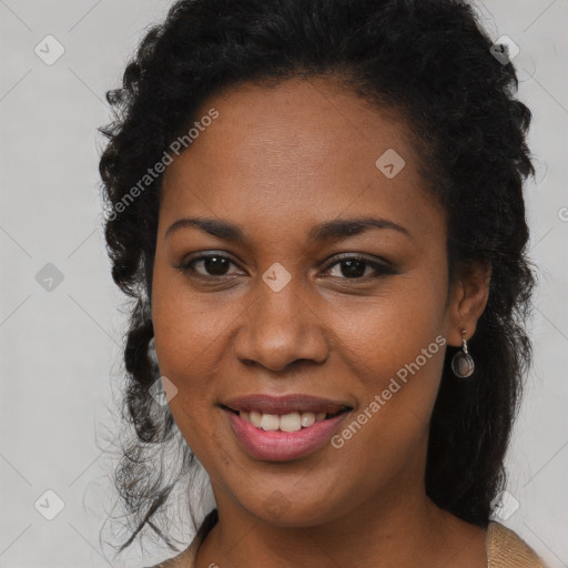 Joyful black young-adult female with long  brown hair and brown eyes