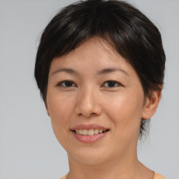 Joyful asian young-adult female with short  brown hair and brown eyes