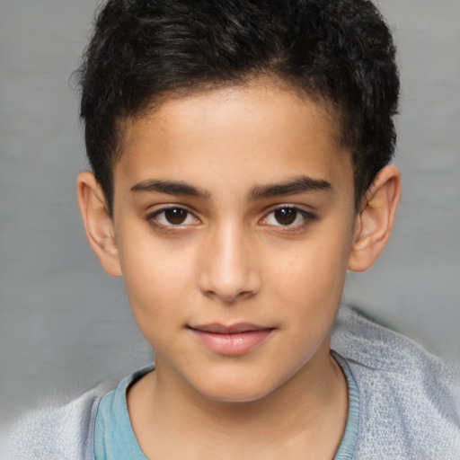 Joyful latino child male with short  brown hair and brown eyes