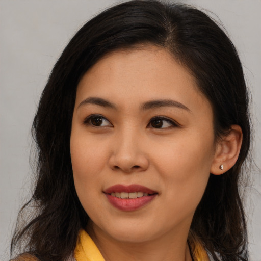 Joyful asian young-adult female with long  brown hair and brown eyes