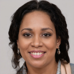 Joyful latino young-adult female with long  brown hair and brown eyes