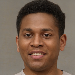 Joyful latino young-adult male with short  brown hair and brown eyes