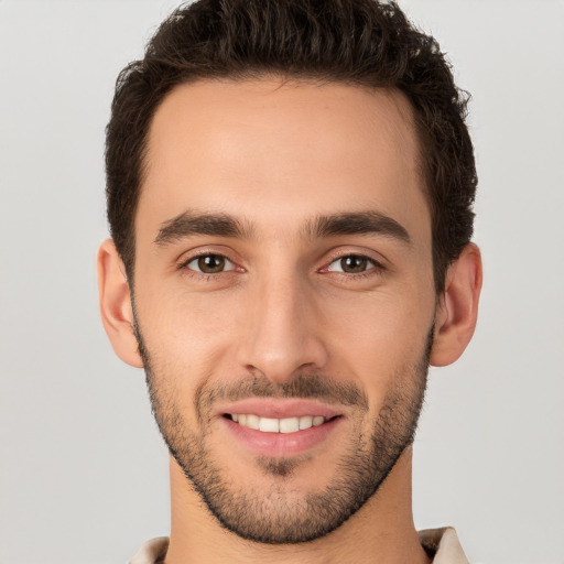 Joyful white young-adult male with short  brown hair and brown eyes