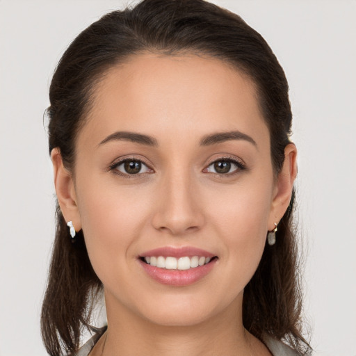 Joyful white young-adult female with long  brown hair and brown eyes