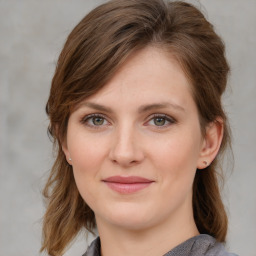 Joyful white young-adult female with medium  brown hair and blue eyes