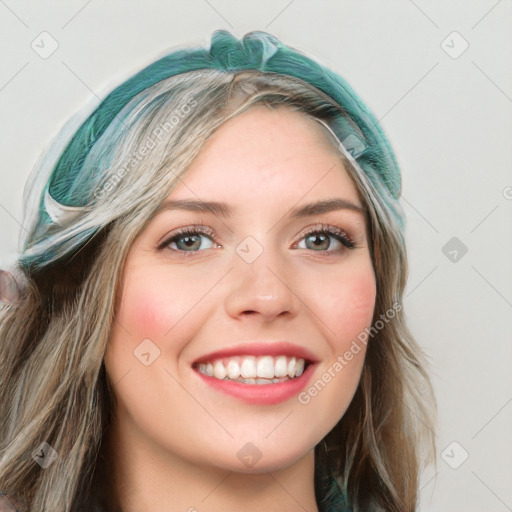 Joyful white young-adult female with long  brown hair and blue eyes