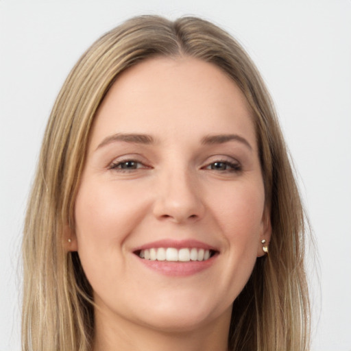 Joyful white young-adult female with long  brown hair and brown eyes