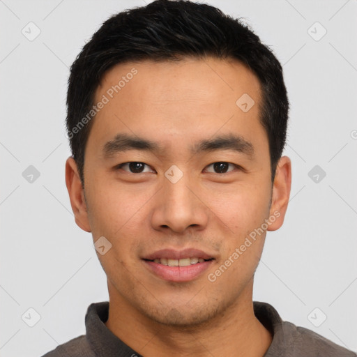 Joyful asian young-adult male with short  brown hair and brown eyes