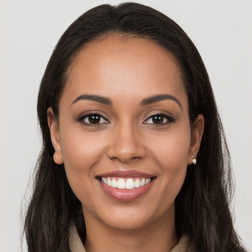 Joyful latino young-adult female with long  brown hair and brown eyes