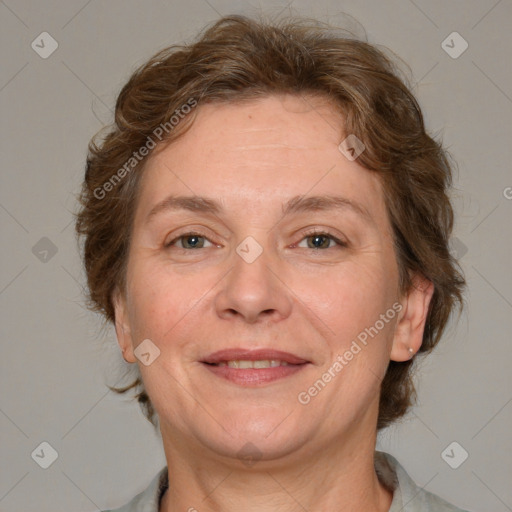 Joyful white adult female with medium  brown hair and blue eyes