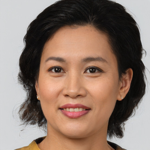 Joyful asian young-adult female with medium  brown hair and brown eyes