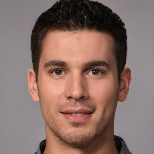 Joyful white young-adult male with short  brown hair and brown eyes