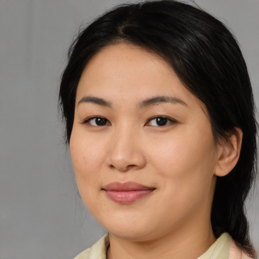 Joyful asian young-adult female with medium  black hair and brown eyes