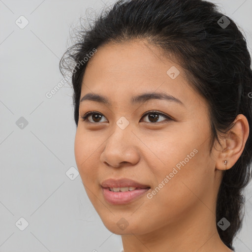 Joyful latino young-adult female with long  brown hair and brown eyes