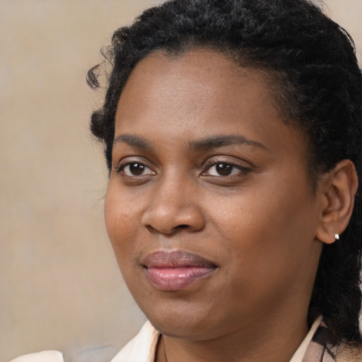 Joyful black young-adult female with medium  black hair and brown eyes