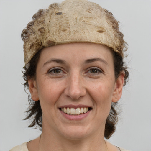 Joyful white adult female with medium  brown hair and grey eyes