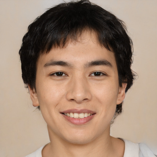 Joyful asian young-adult male with medium  brown hair and brown eyes