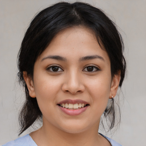 Joyful white young-adult female with medium  brown hair and brown eyes