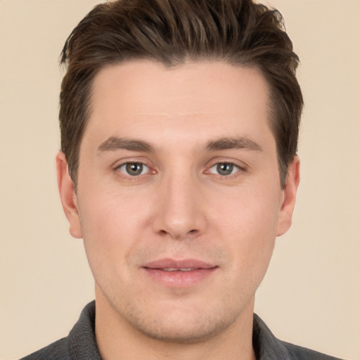 Joyful white young-adult male with short  brown hair and brown eyes