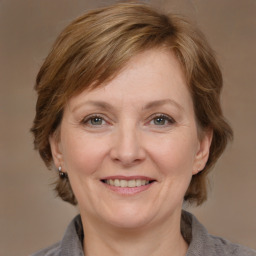 Joyful white adult female with medium  brown hair and brown eyes