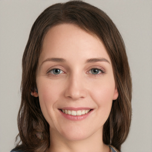 Joyful white young-adult female with medium  brown hair and green eyes