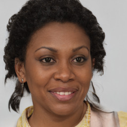 Joyful black adult female with short  brown hair and brown eyes