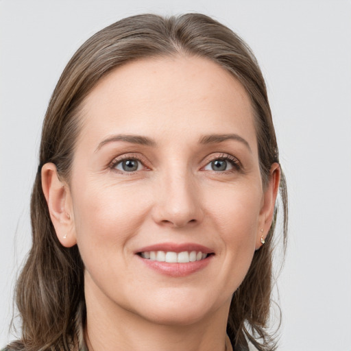 Joyful white young-adult female with long  brown hair and grey eyes