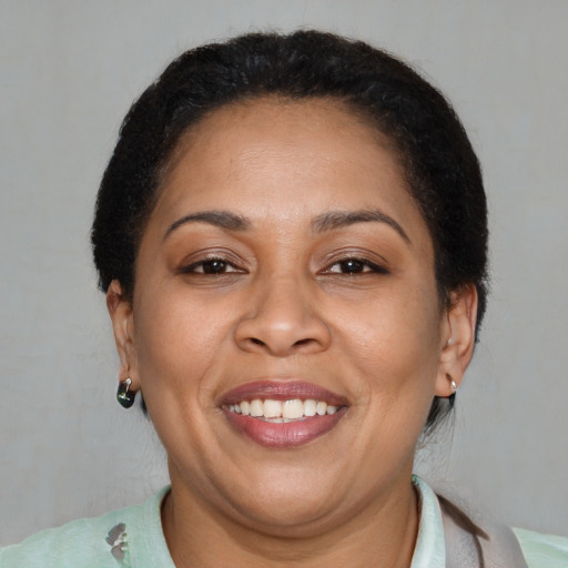 Joyful latino adult female with short  brown hair and brown eyes