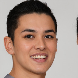 Joyful latino young-adult male with short  brown hair and brown eyes