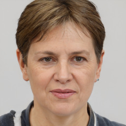 Joyful white adult female with short  brown hair and grey eyes