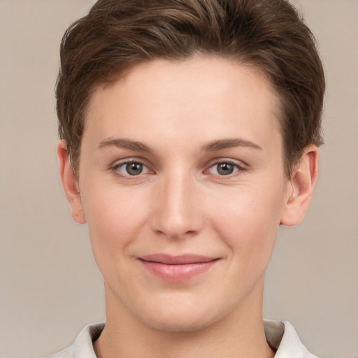 Joyful white young-adult female with short  brown hair and grey eyes