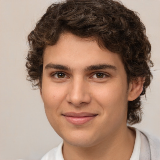 Joyful white young-adult male with medium  brown hair and brown eyes