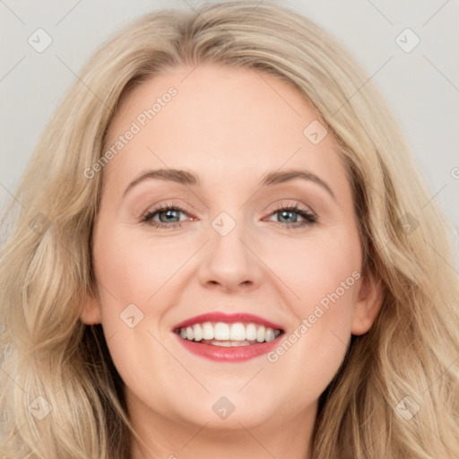 Joyful white young-adult female with long  brown hair and blue eyes