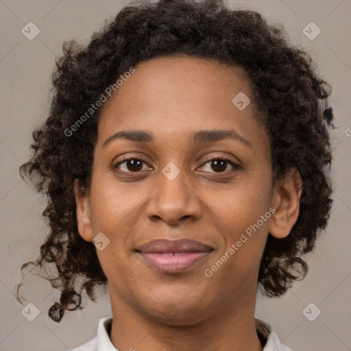 Joyful black adult female with short  brown hair and brown eyes