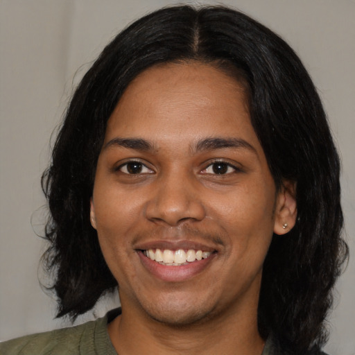 Joyful black young-adult female with medium  black hair and brown eyes