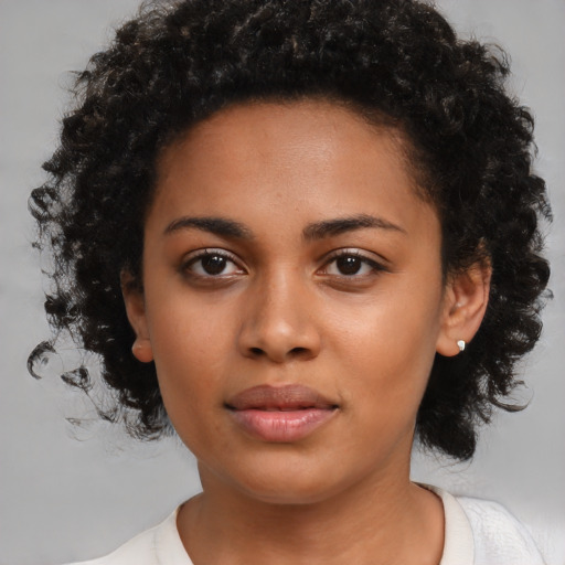 Neutral black young-adult female with medium  brown hair and brown eyes