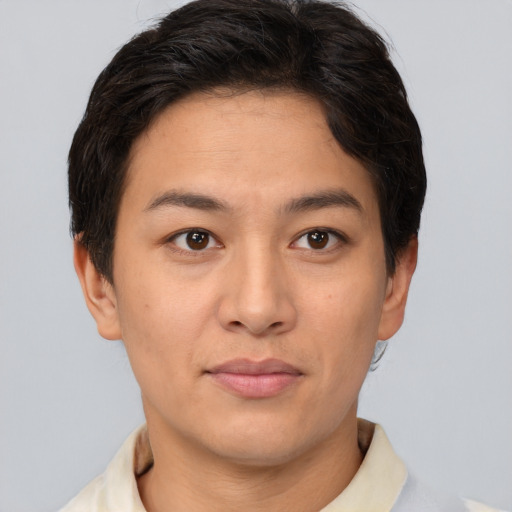 Joyful asian young-adult female with short  brown hair and brown eyes