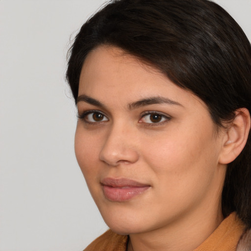 Joyful latino young-adult female with medium  brown hair and brown eyes